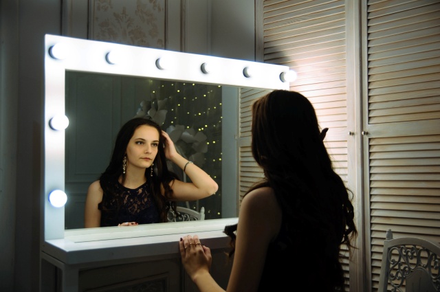 鏡に映る自分の姿を見つめる女性