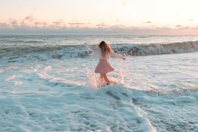 波のなかに立つ女性